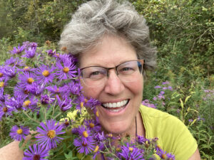 Julie Zickefoose with a bunch of asters
